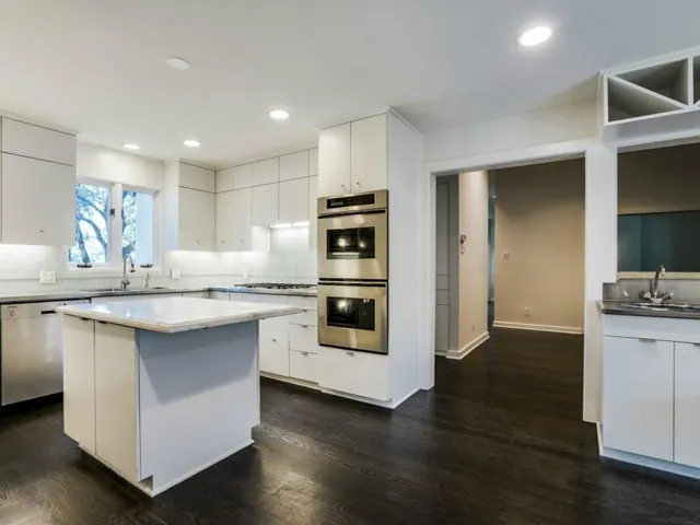 a kitchen with stainless steel appliances granite countertop a stove and a refrigerator