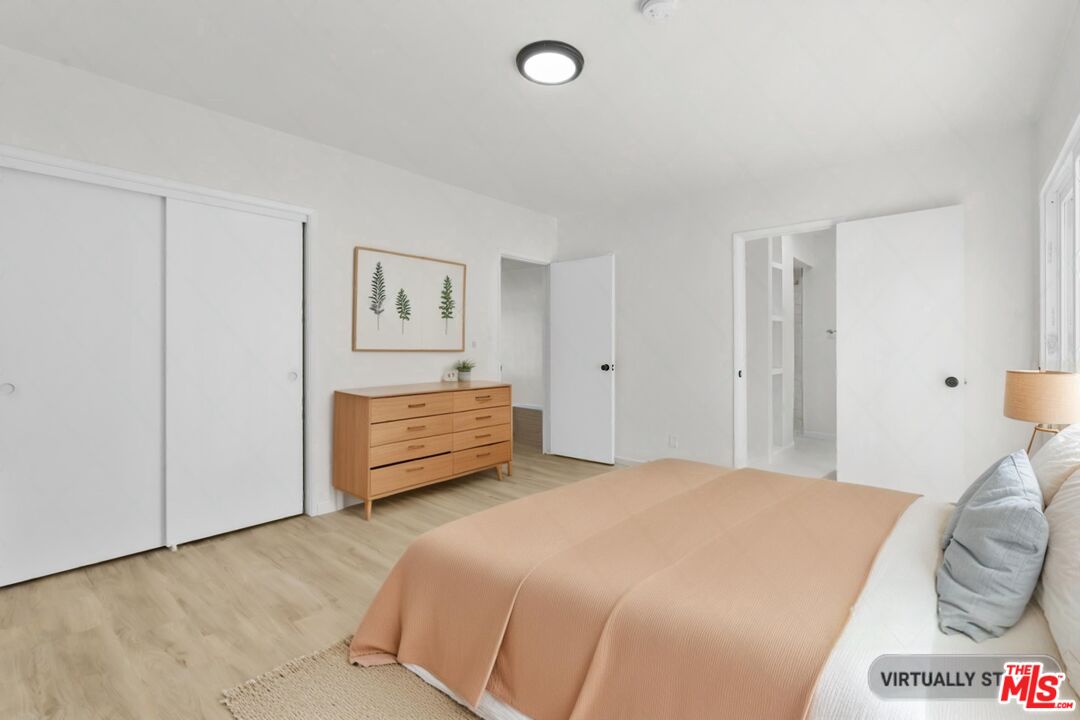 a bedroom with a bed and a lamp