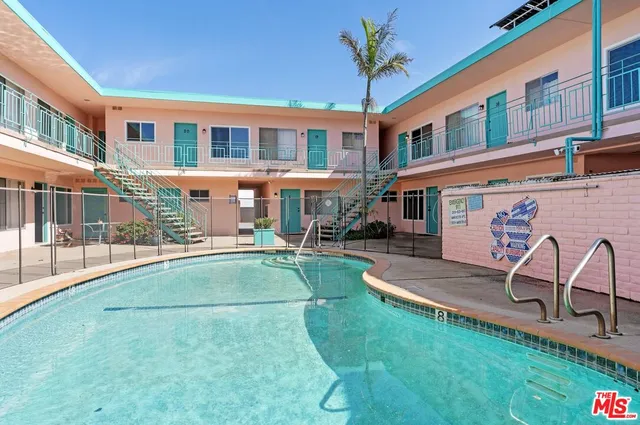 a view of a building with a backyard porch and sitting area