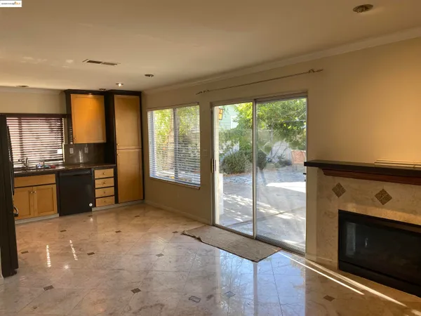 a open kitchen with granite countertop a stove top oven a sink and a refrigerator