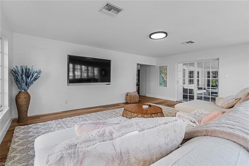 1823 Hurricane Harbor Lane Naples, FL 34102 - Photo 13 of 30 a bedroom with a bed and a chair