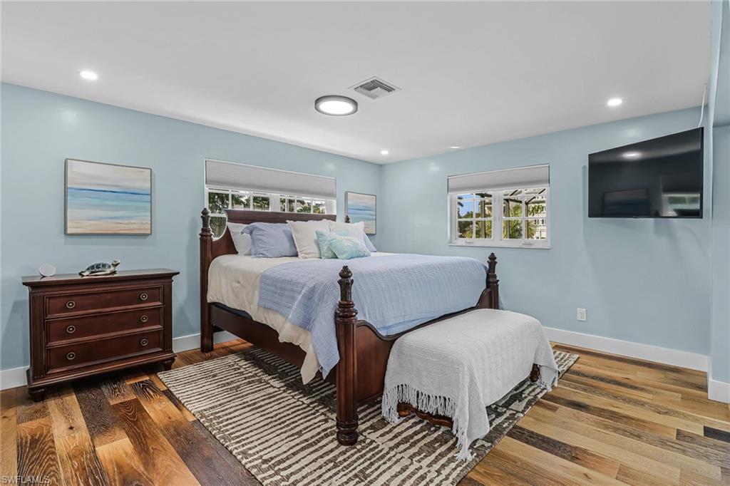 1823 Hurricane Harbor Lane Naples, FL 34102 - Photo 15 of 30 a bedroom with a bed and a flat screen tv