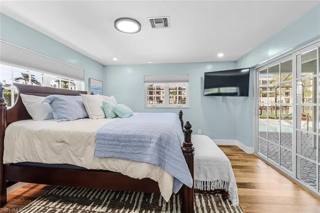 a bedroom with a large bed and a tv