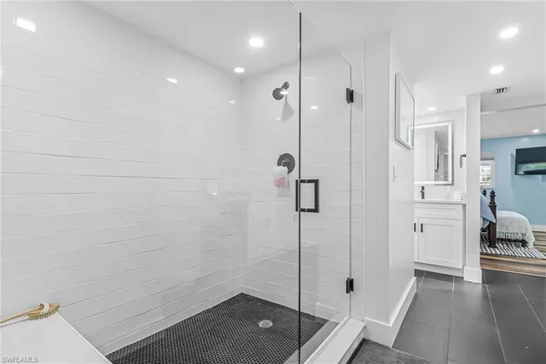 a bathroom with a shower and a sink