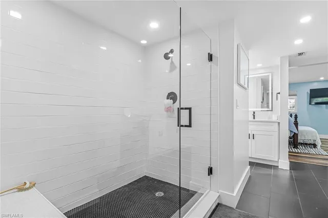 a bathroom with a shower and a sink