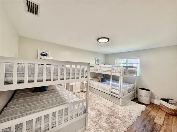 a view of a bedroom with furniture and windows