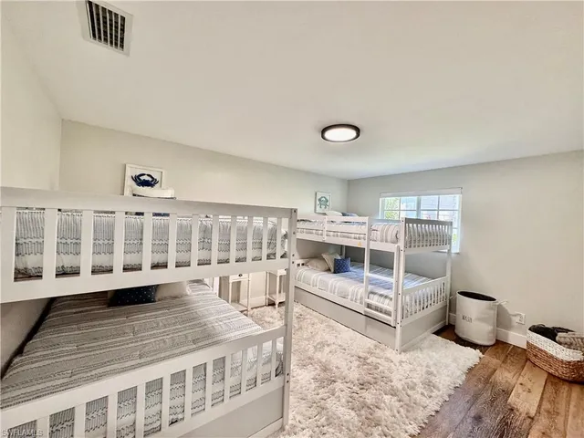 a view of a bedroom with furniture and windows