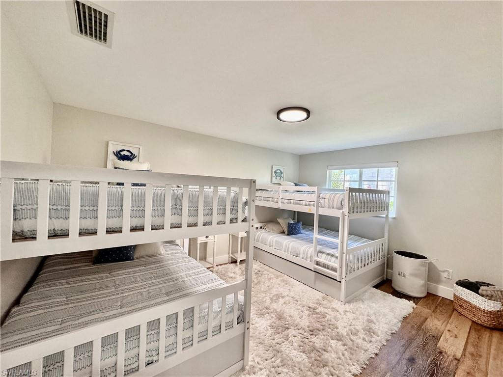 1823 Hurricane Harbor Lane Naples, FL 34102 - Photo 22 of 30 a view of a bedroom with furniture and windows