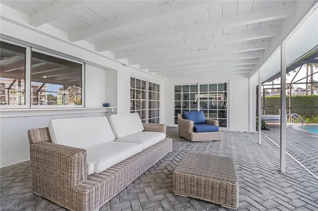 a living room with furniture and large window