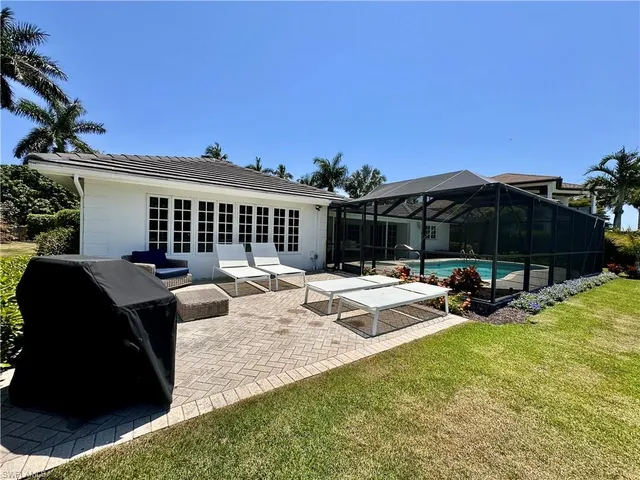 a view of a house with backyard porch and sitting area