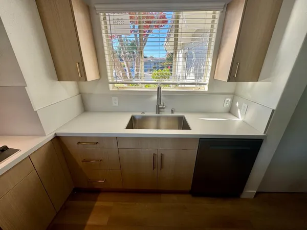 a kitchen with a sink and a window