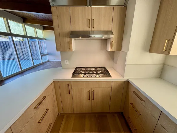 a kitchen with granite countertop white cabinets and white appliances