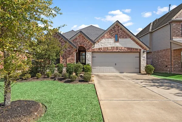 a view of a house with a yard and potted plants