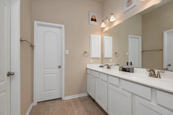 a bathroom with a double vanity sink and mirror