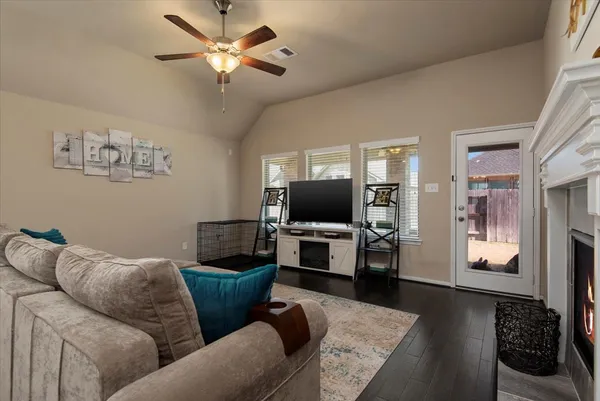 a living room with furniture and a flat screen tv