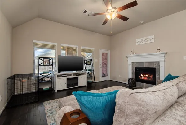 a living room with furniture and a fireplace