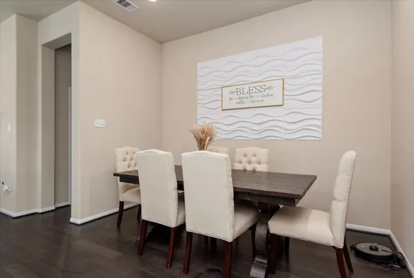 a view of a dining room with furniture and wooden floor