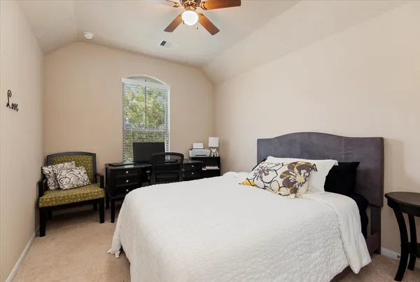 a bedroom with bed and window