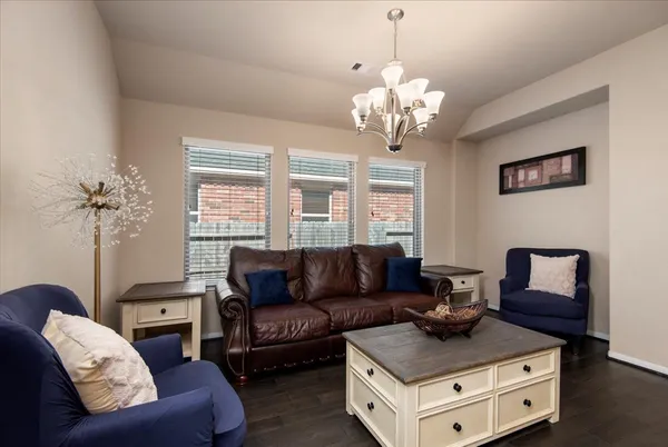 a living room with furniture and a chandelier