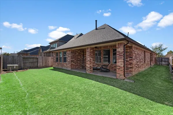 a view of a house with a yard and deck