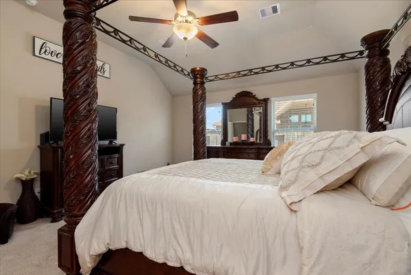 a bedroom with a bed and a mirror