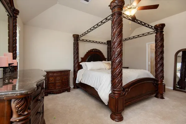 a bedroom with a bed and a desk