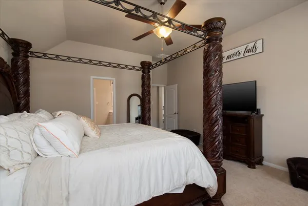 a bedroom with a bed and a flat tv screen