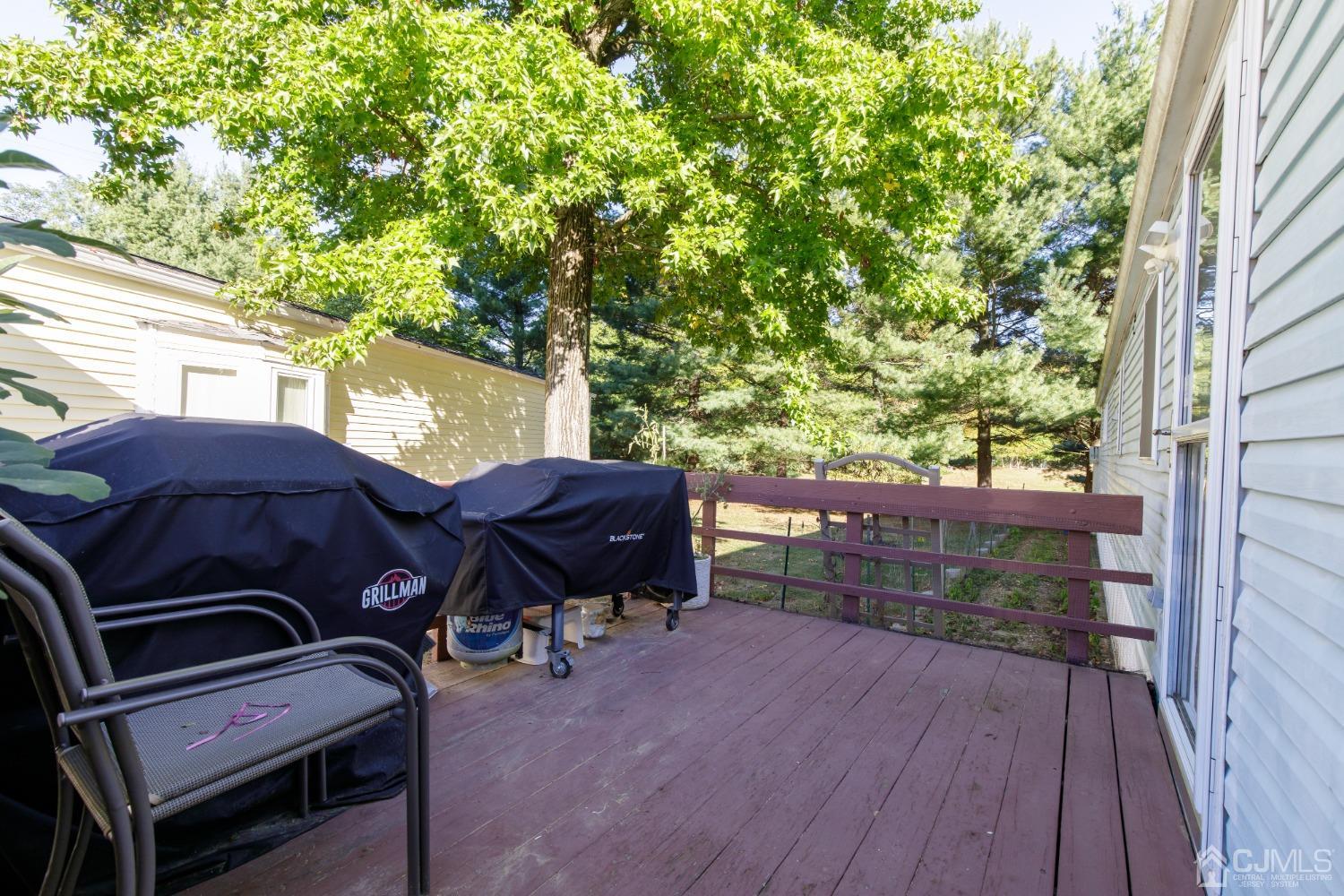 57 Burns Road North Brunswick, NJ 08902 - Photo 8 of 26 a view of a roof deck with table and chairs a barbeque with wooden floor and fence