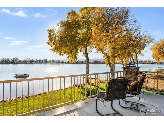 a view of a lake with table and chairs