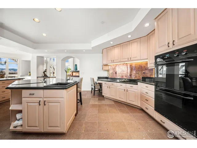 a kitchen with stainless steel appliances granite countertop a sink and cabinets