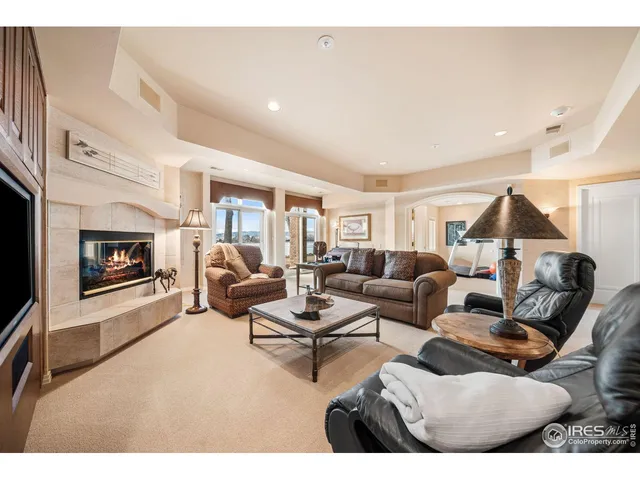 a living room with furniture wooden floor and a fireplace