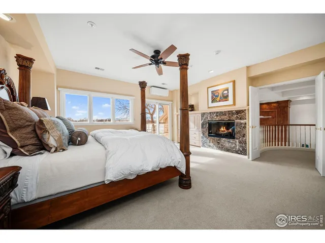 a bedroom with a bed couch and a fireplace