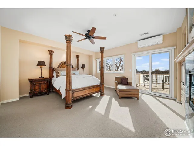 a bedroom with furniture and a large window