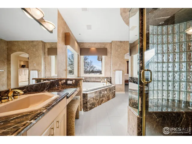 a en suite bathroom with a sink and a large mirror