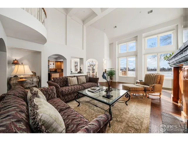 a living room with furniture a fireplace and a large window