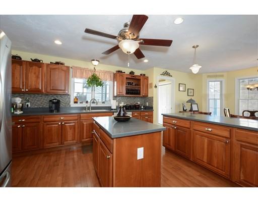 244 East County Road Rutland, MA 01543 - Photo 8 of 30 a kitchen with stainless steel appliances a sink stove and wooden cabinets
