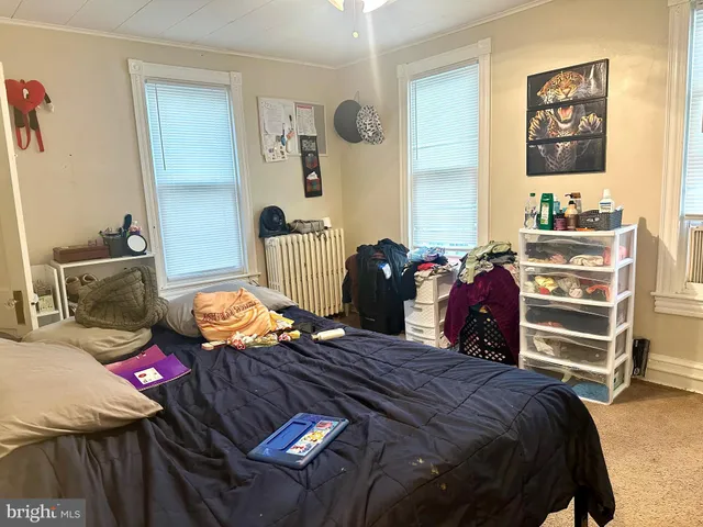 a bedroom with furniture and a mirror