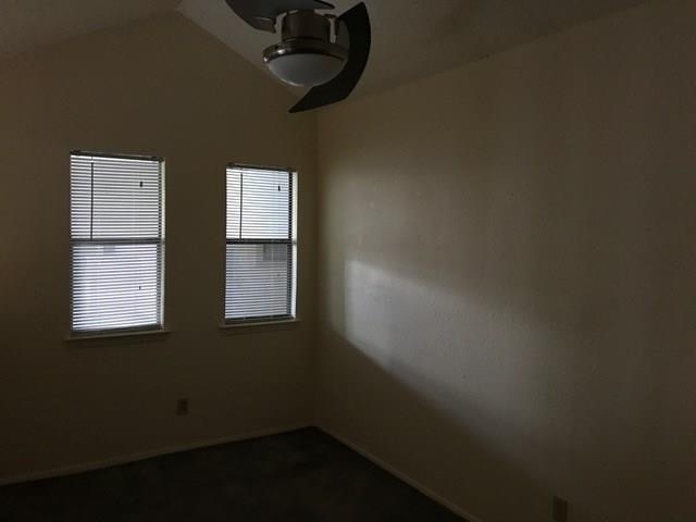 2500 Burleson Road, Unit 312 Austin, TX 78741 - Photo 3 of 6 Angled ceilings and a ceiling fan enhance comfort in this well-lit room with two windows.