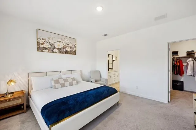 a bedroom with a bed and a couch