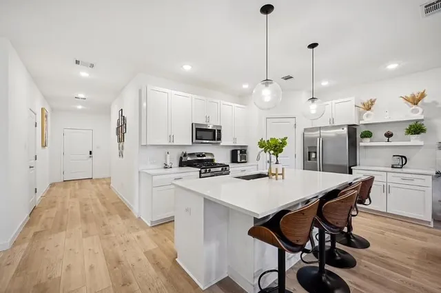 a view of kitchen with cabinets table and chairs