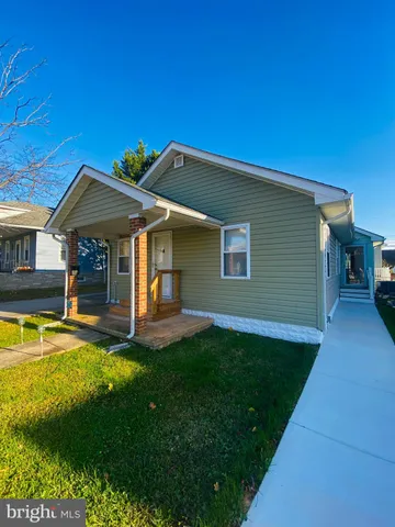 a view of a house with a yard patio and swimming pool