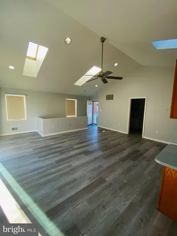 a view of a room with wooden floor