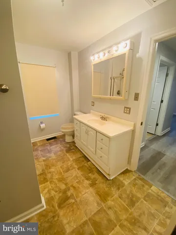 a bathroom with a tub a sink and a mirror