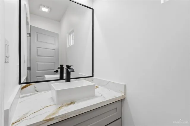a bathroom with a sink and a mirror