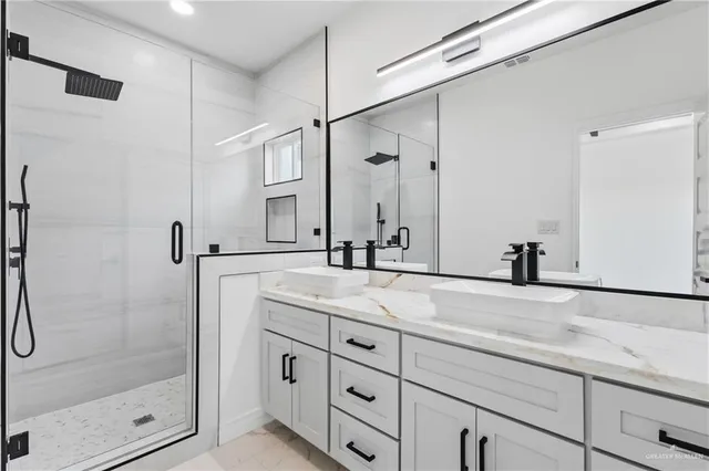 a bathroom with a shower sink and mirror