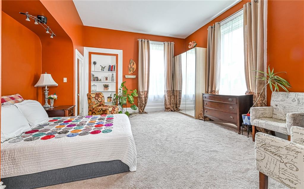 381 Friday Road Pittsburgh, PA 15209 - Photo 12 of 44 a bedroom with a bed and large windows