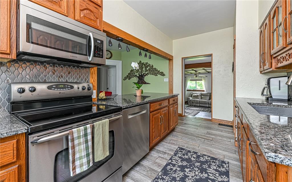 381 Friday Road Pittsburgh, PA 15209 - Photo 28 of 44 a kitchen with stainless steel appliances granite countertop a stove and a microwave