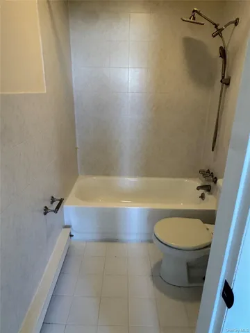 a bathroom with a bathtub and toilet