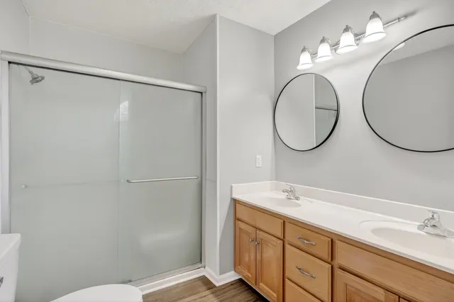 a bathroom with a sink mirror vanity and toilet