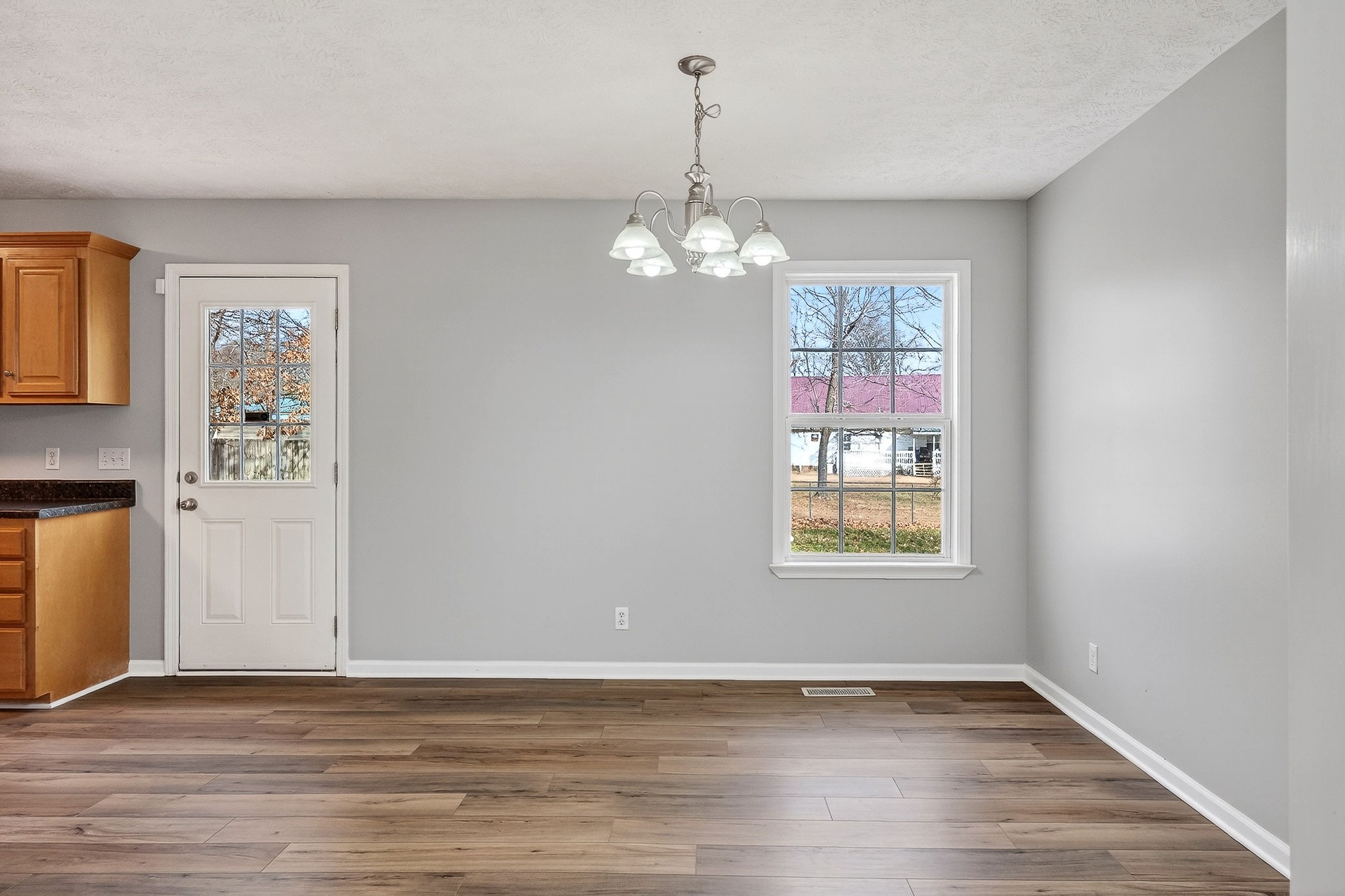 325 Indian Springs Circle Manchester, TN 37355 - Photo 6 of 29 a view of an empty room with window and wooden floor